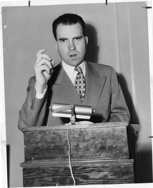 Richard Nixon speaking at a podium during his senatorial campaign.